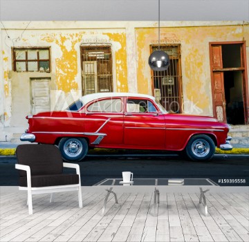 Picture of Vibrant red shiny car and ruined house in Cuba